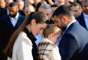 a family during the burial of a loved one